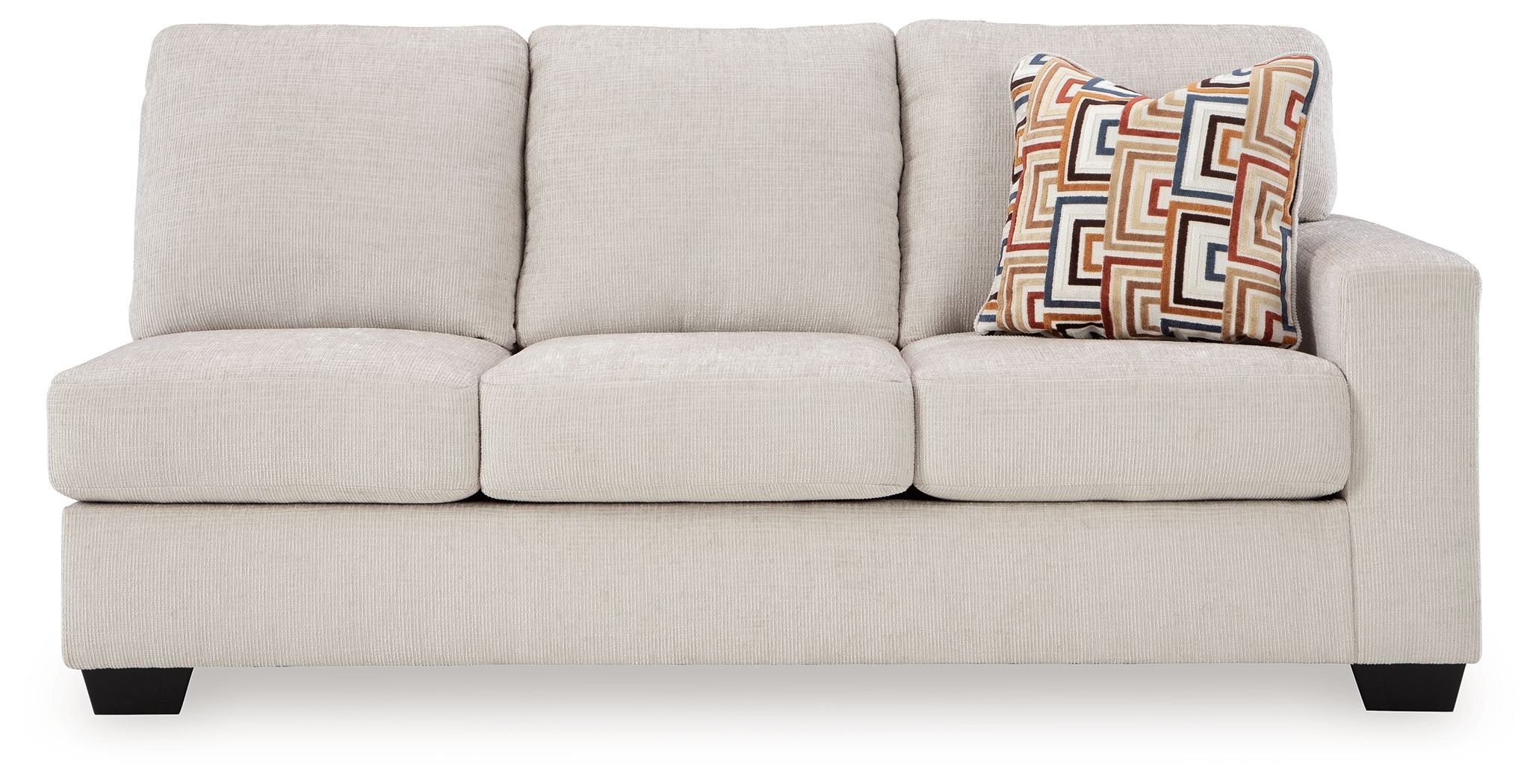 Light beige fabric sofa with three seat cushions, three back cushions, and geometric throw