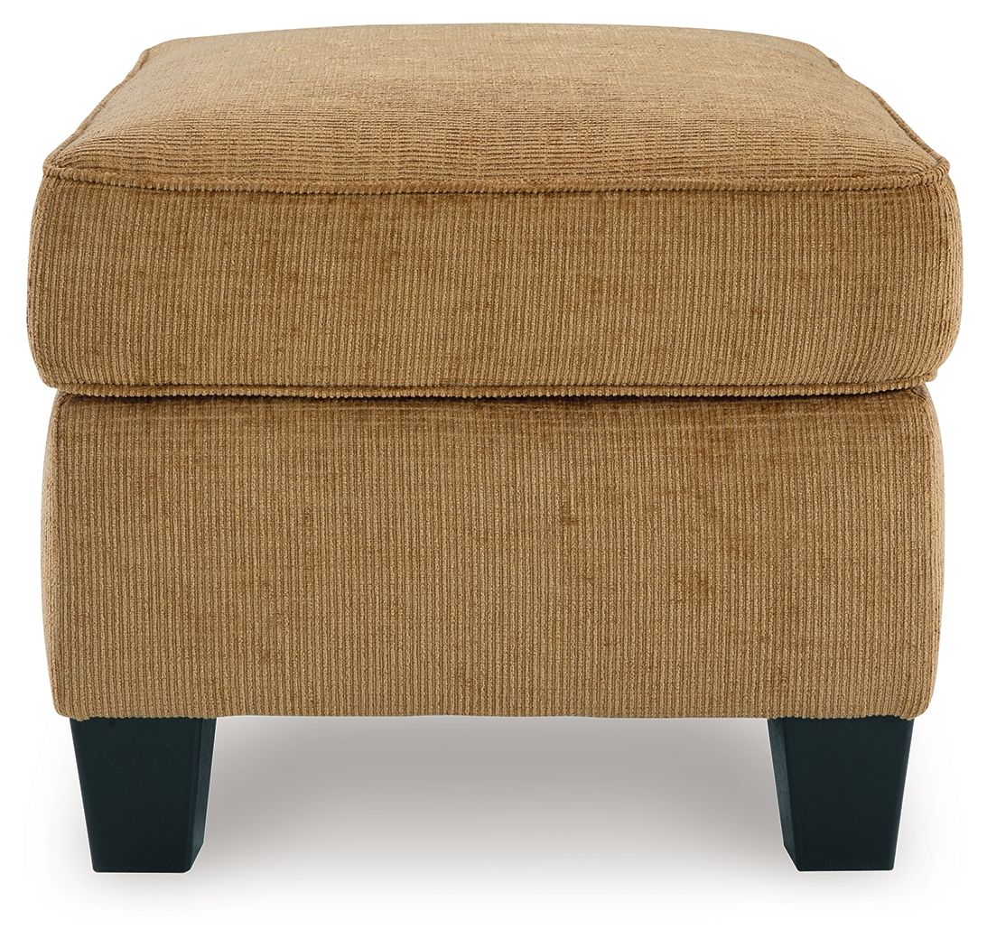 Light brown ottoman with cushioned top and side panels, dark block legs
