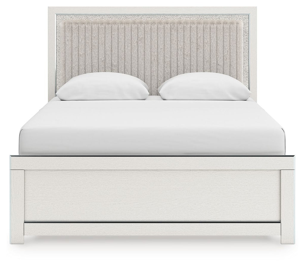 White upholstered panel bed with channel-tufted headboard, two white pillows, and paneled base