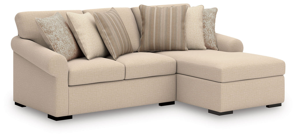 Beige sectional with corner chaise, square arms, and patterned accent pillows