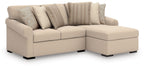 Beige sectional with corner chaise, square arms, and patterned accent pillows