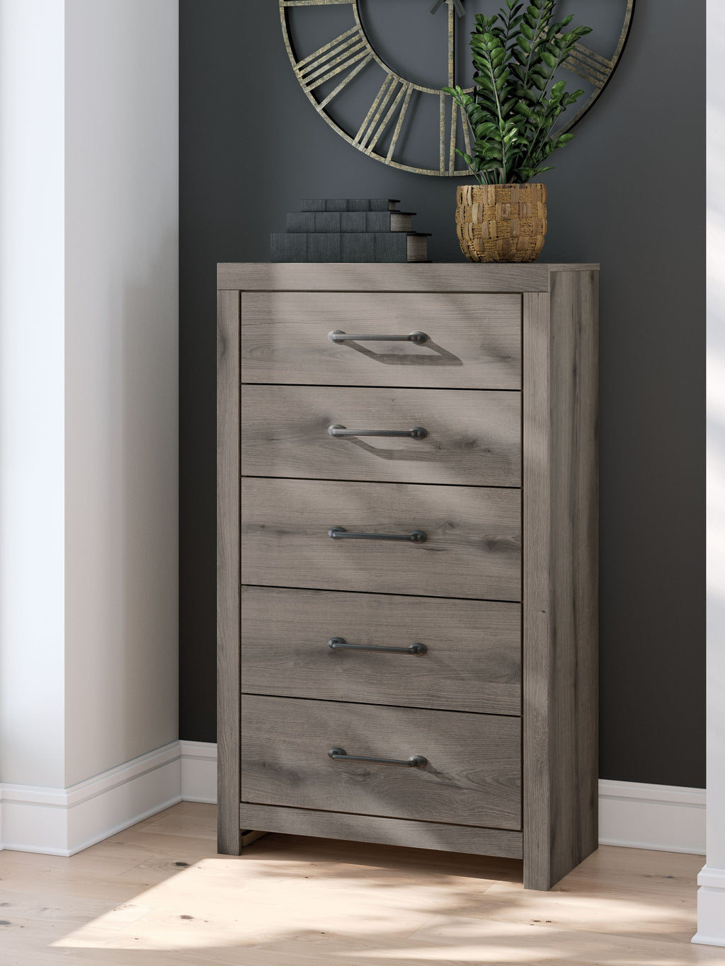 Five-drawer chest in gray wood with metal bar pulls, full front view.