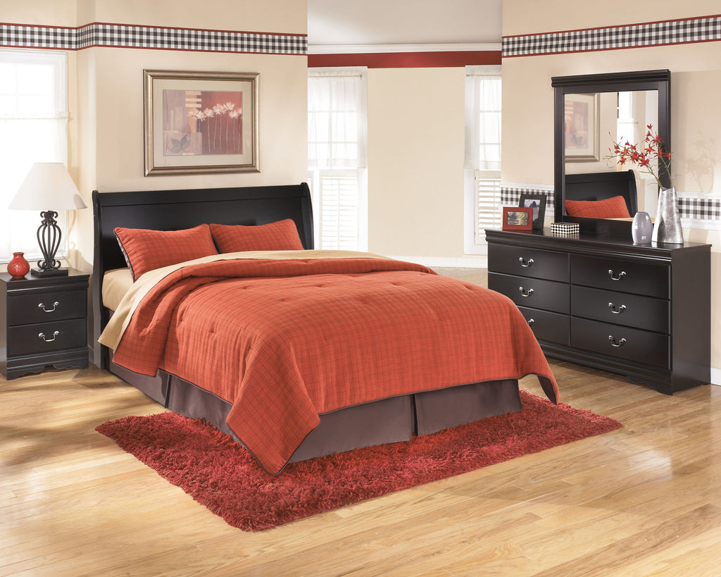 Black queen sleigh headboard with curved upholstered top, styled bedroom bedding