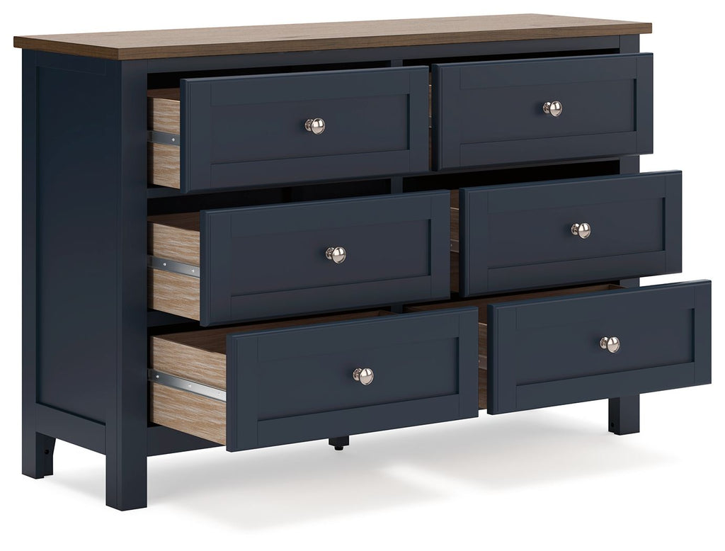 Blue dresser with exposed wood drawer interiors and round silver knobs