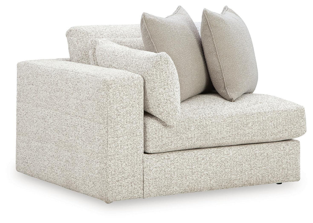 Snowstone corner chair with light textured fabric, square arms, and three back cushions
