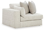 Snowstone corner chair with light textured fabric, square arms, and three back cushions