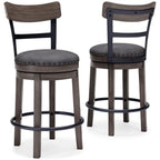 Gray upholstered swivel bar stool with round seat, nailhead trim, and curved footrest