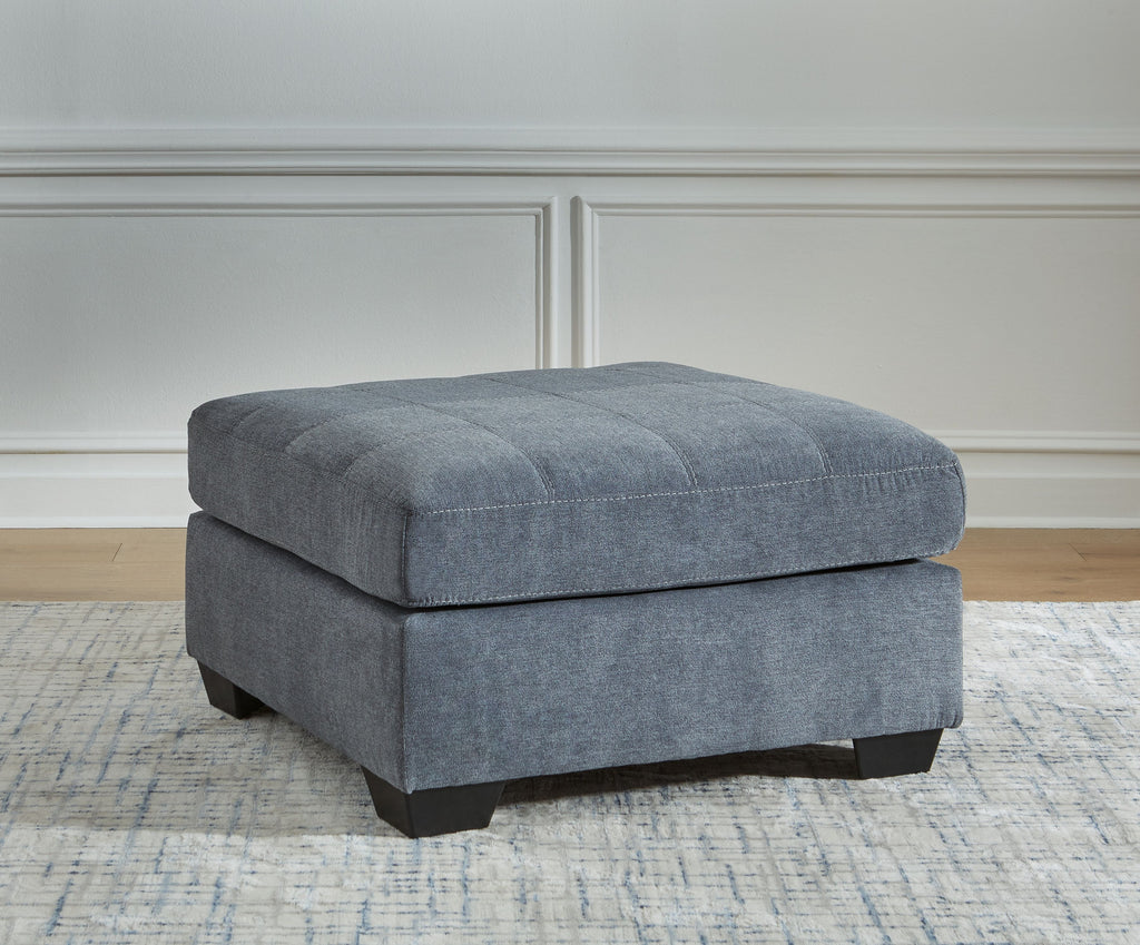 Oversized accent ottoman in dark gray with rounded top and dark wooden legs