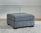 Oversized accent ottoman in dark gray with rounded top and dark wooden legs