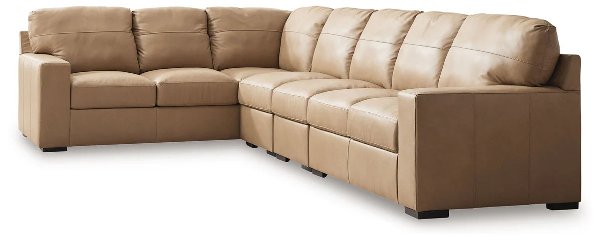 Two-tone sectional sofa with tufted back, curved seat blocks, and tan-and-cream upholstery