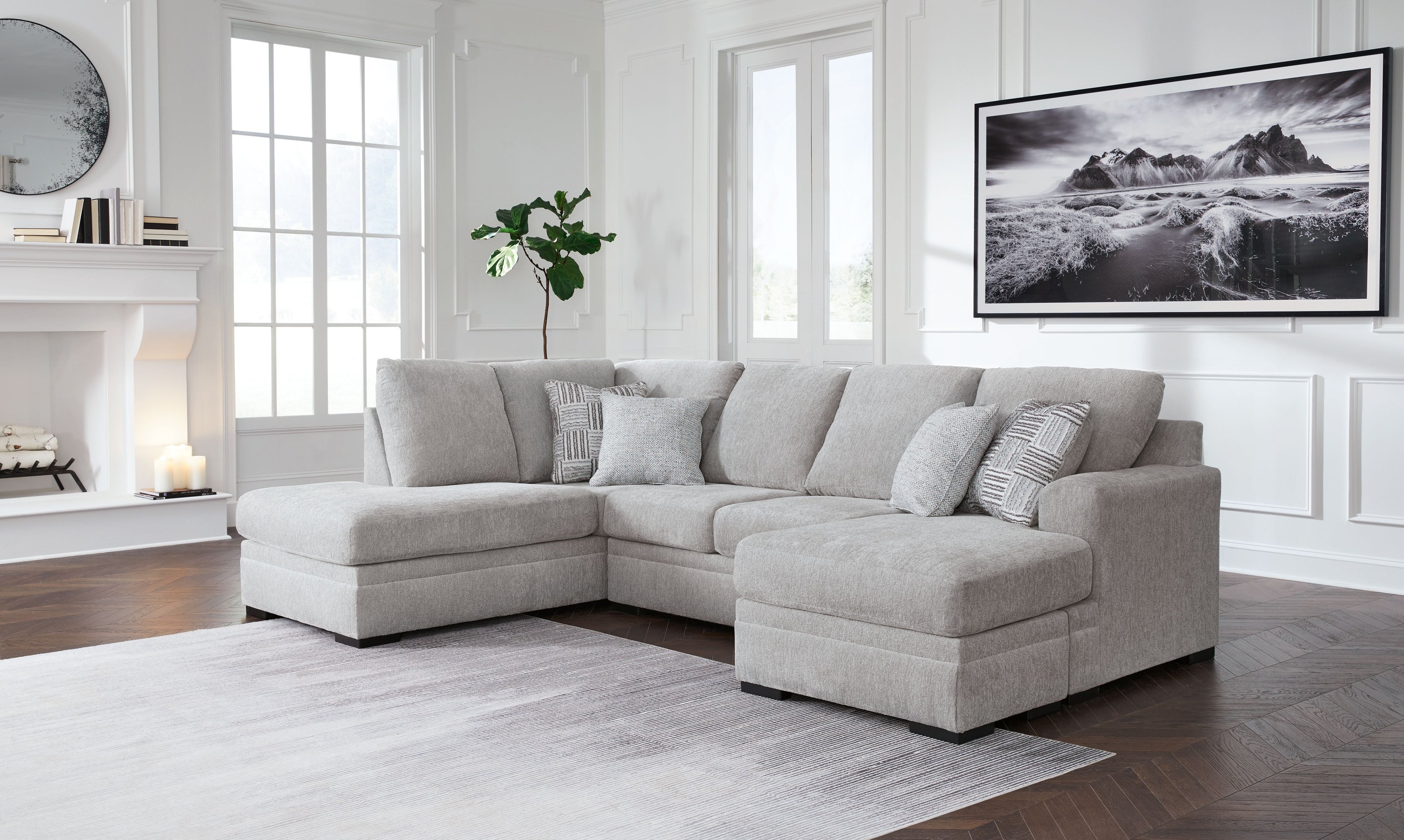 Gray sectional sofa with chaise, three seat back cushions, rounded arms, dark legs