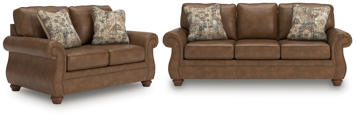 Dark brown loveseat sofa with two patterned accent pillows and rolled arms