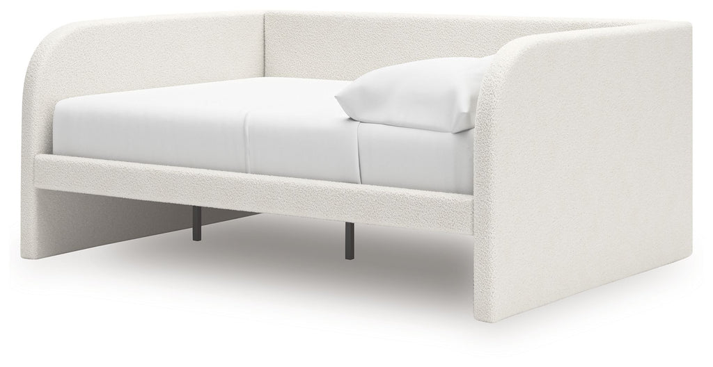 Beige upholstered day bed with open slatted base and tapered legs