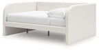 Beige upholstered day bed with open slatted base and tapered legs