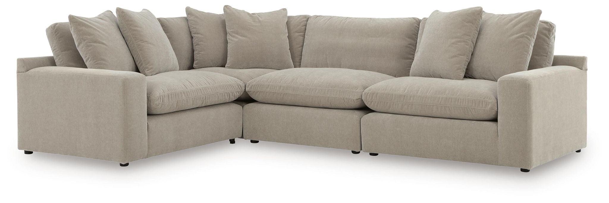 Light gray sectional sofa with chaise-style corner, padded arms, and multiple back cushions.