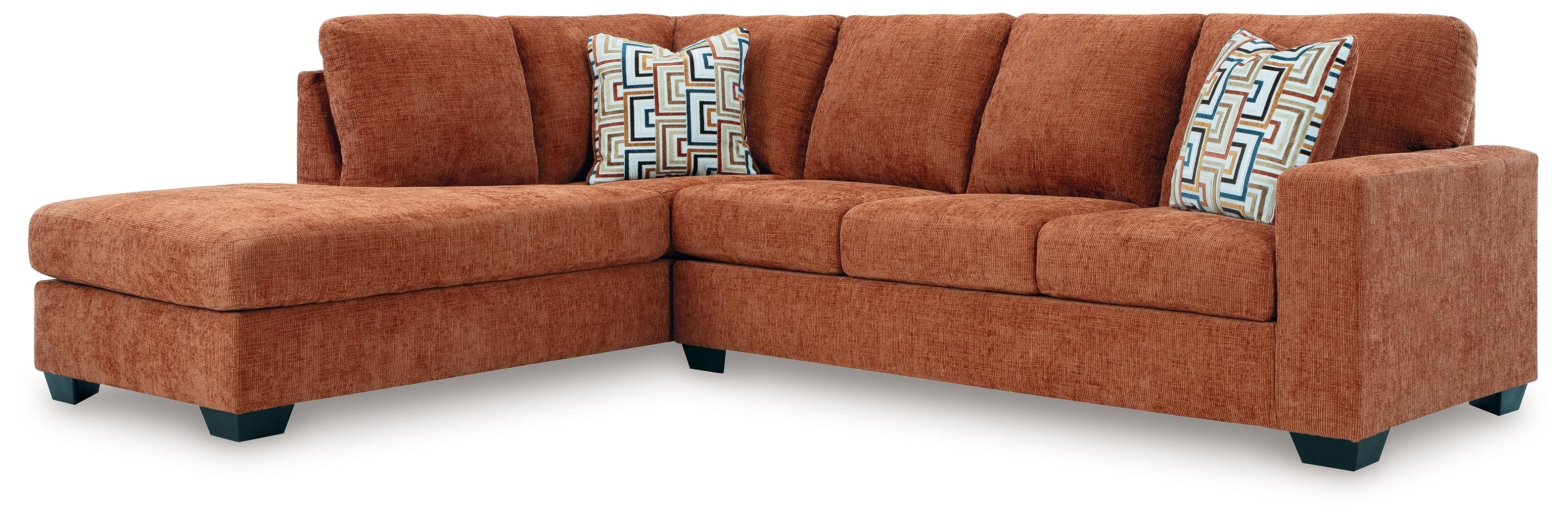 Spice rust sectional sofa with corner chaise and three geometric accent cushions