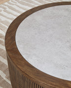 Close-up of gray round tabletop with dark wood curved edge over slatted base.