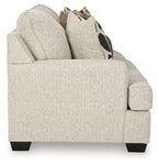 Beige upholstered accent chair with thick arms and visible cushion seams