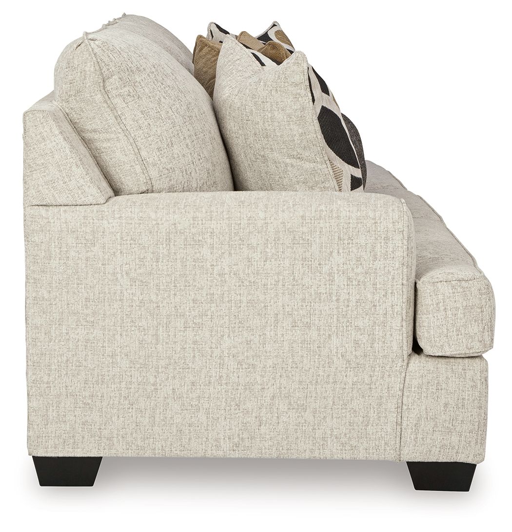 Beige upholstered accent chair with thick arms and visible cushion seams