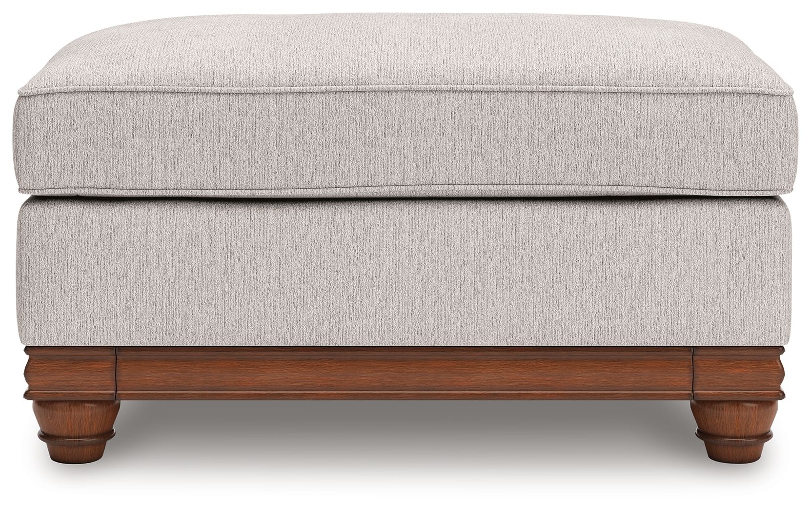 Sandstone upholstered ottoman with padded top and wooden trim base with turned feet