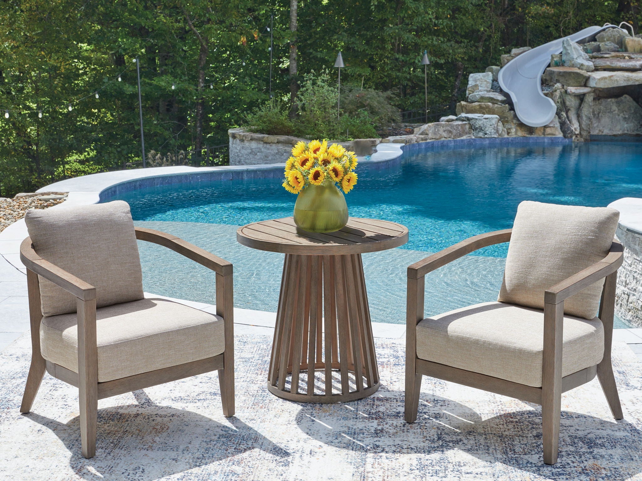 Outdoor seating set with beige upholstered chairs and round slatted wood side table
