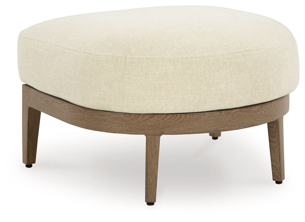 Round ottoman with beige cushion and dark brown wooden legs