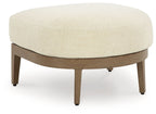 Round ottoman with beige cushion and dark brown wooden legs