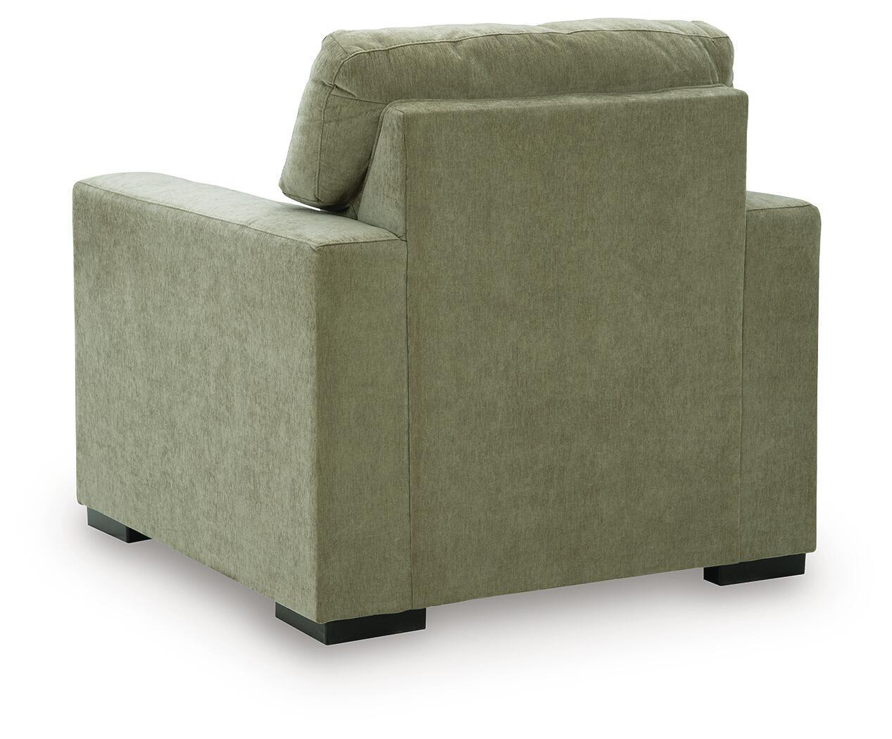 Moss green upholstered armchair with rounded back cushion and block feet
