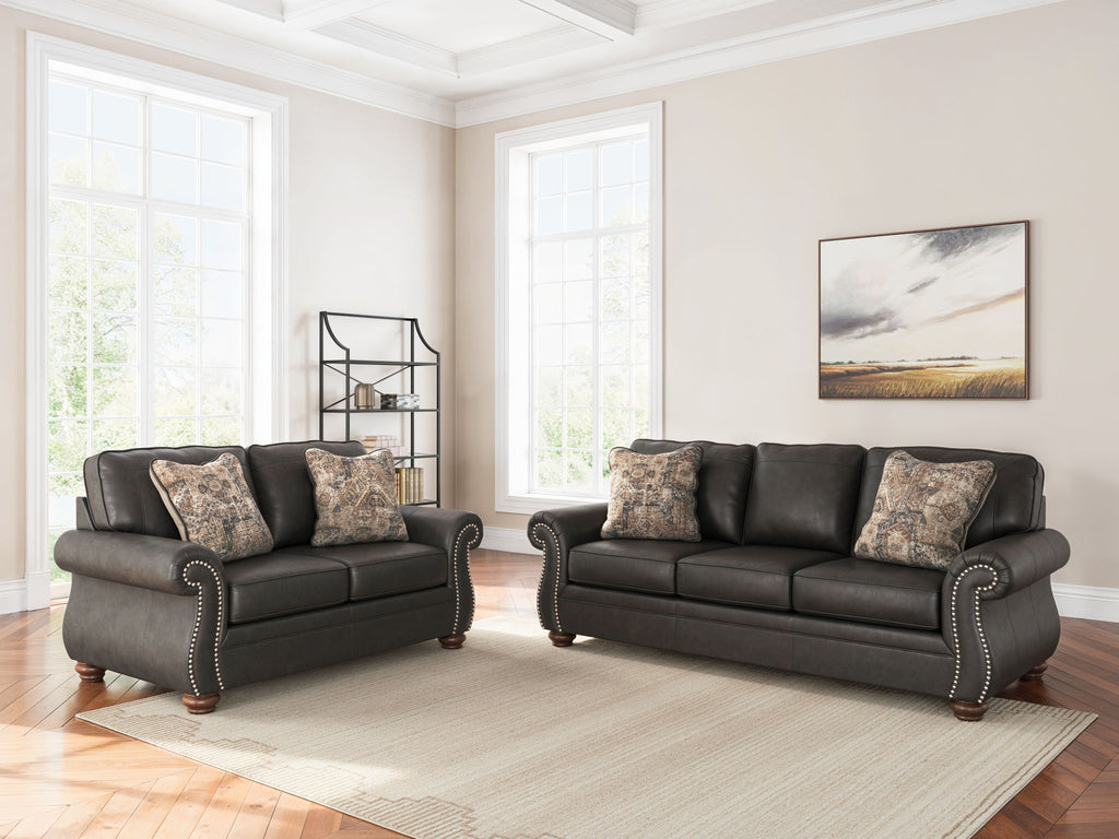 Living room sofa and recliner set with patterned throw pillows