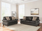 Living room sofa and recliner set with patterned throw pillows