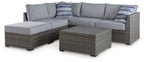 Gray outdoor loveseat sectional with armrests, two ottomans, and coffee table set