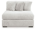 Armless chaise in light gray textured fabric with two decorative pillows and thick seat