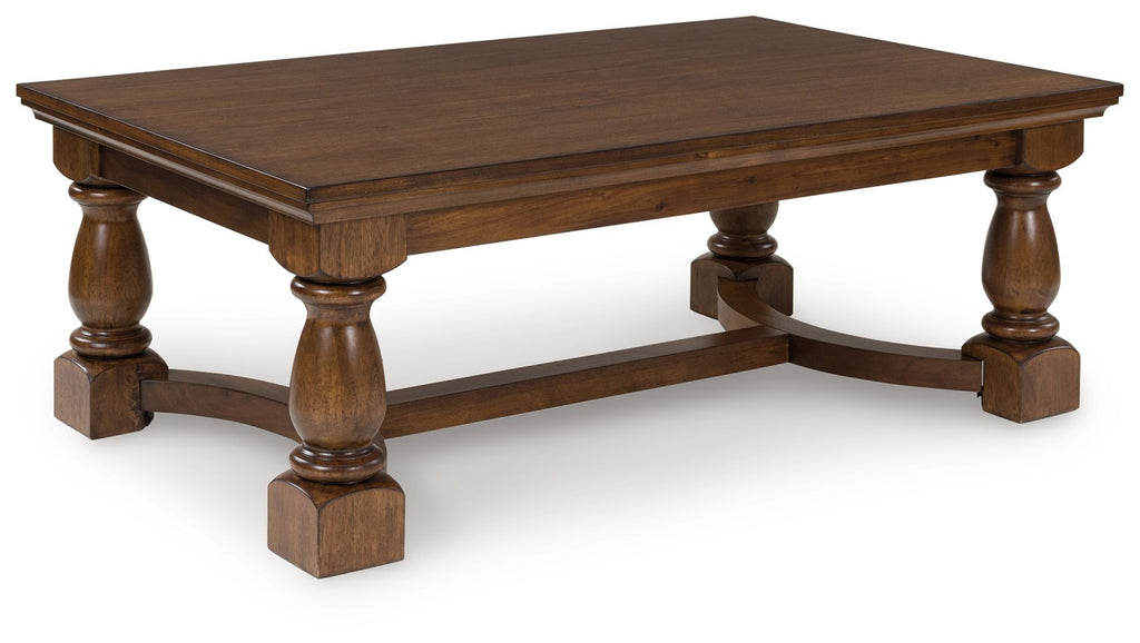 Rectangular brown cocktail table with turned legs and curved apron, open shelf