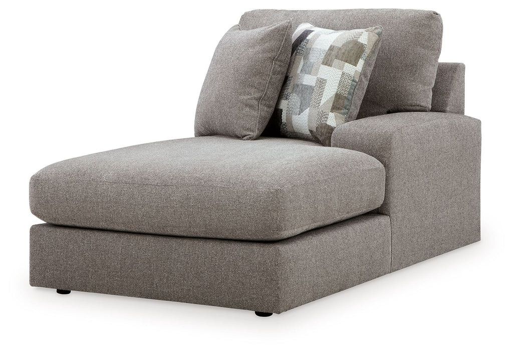 Smoke gray corner chaise with curved armrest and patterned throw pillow