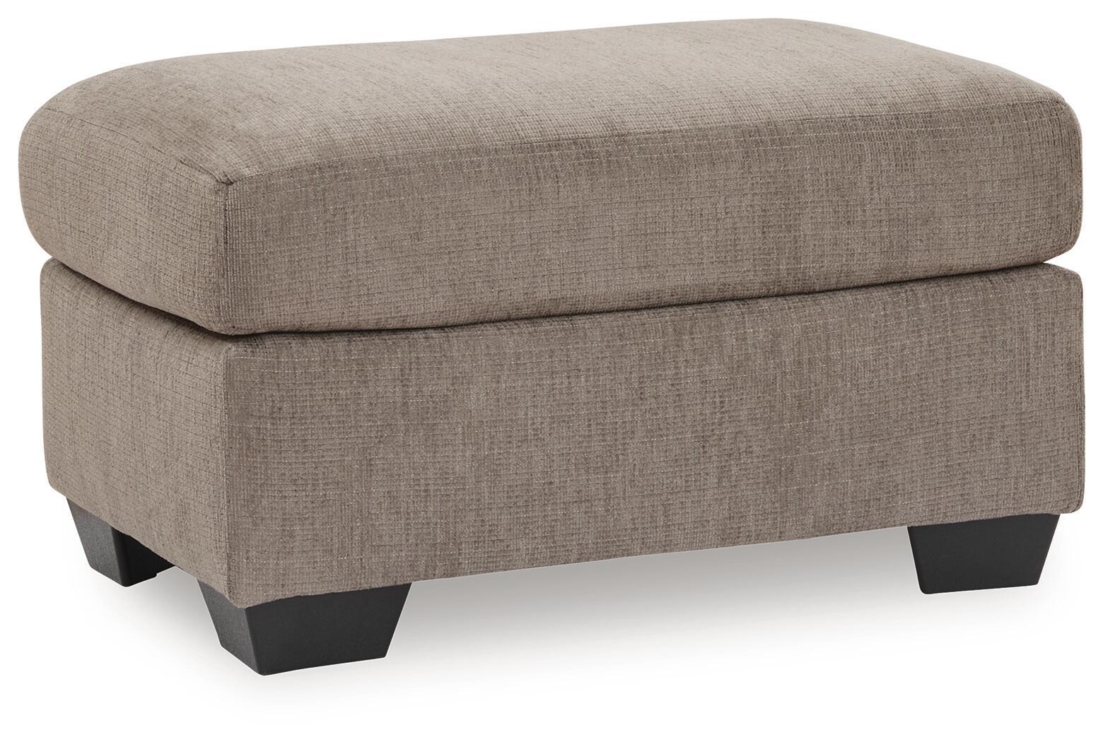 Light brown fabric ottoman with tufted-looking top and dark block feet