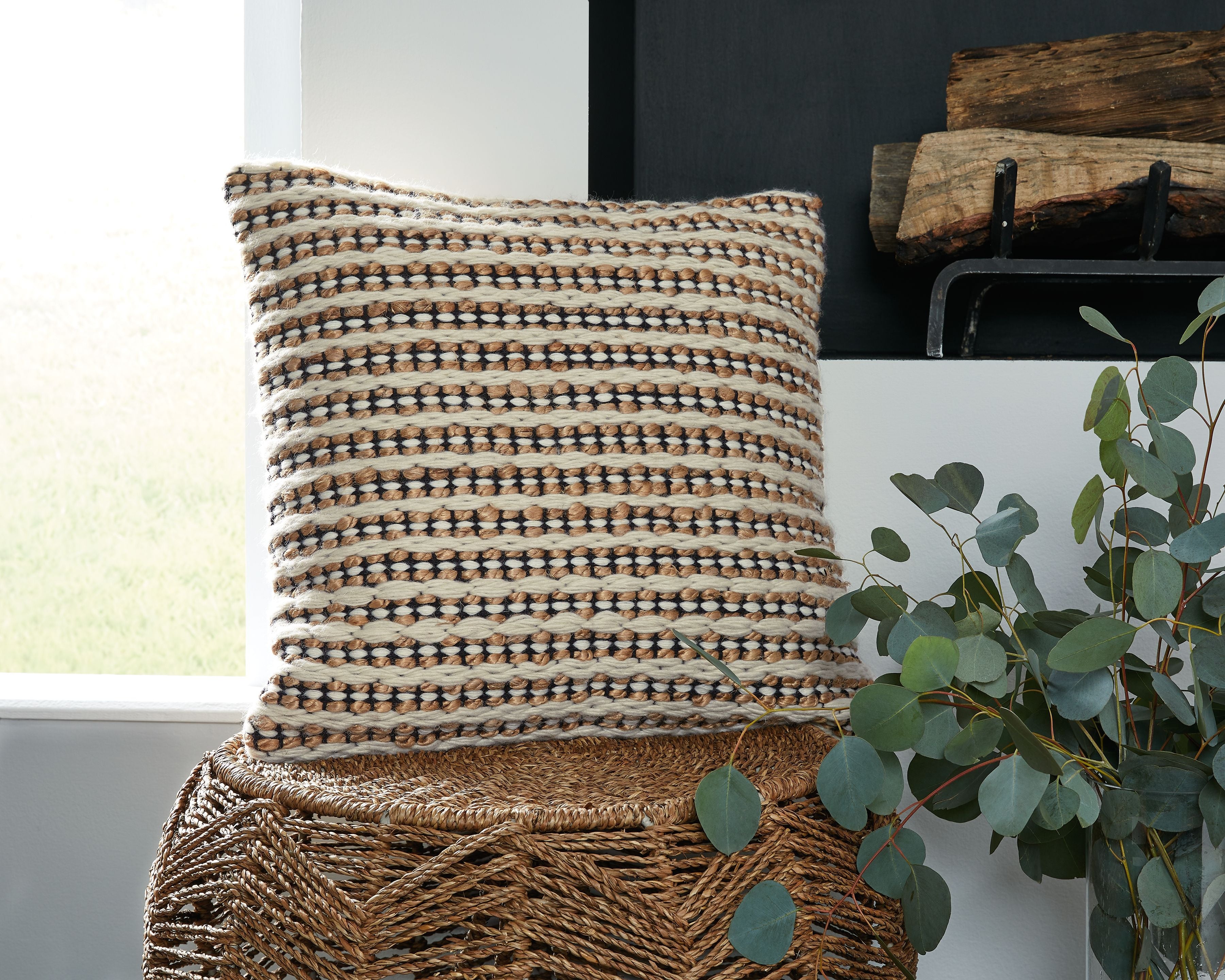 Chunky knit striped throw pillow with brown, black, and white horizontal bands