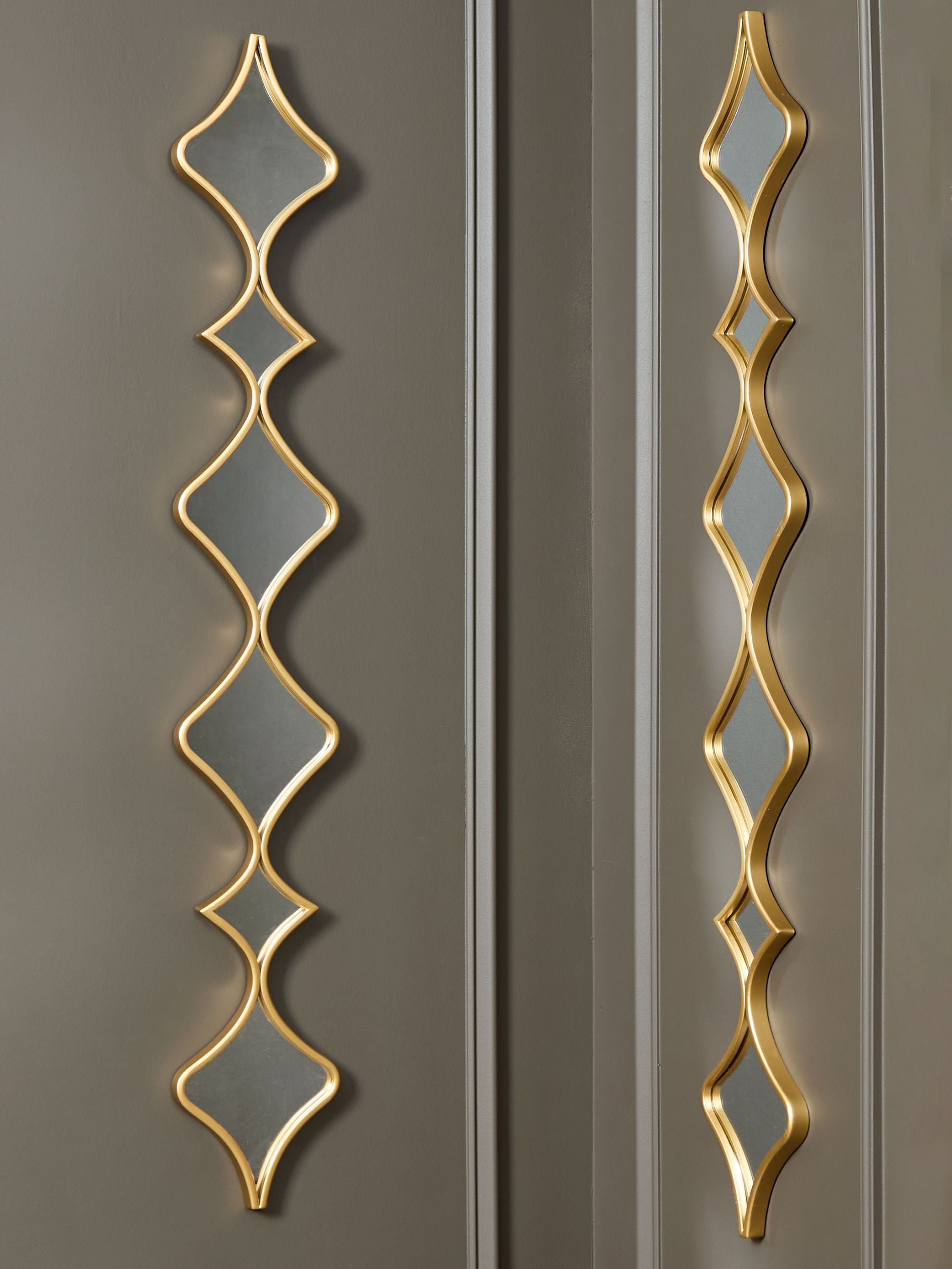 Gold accent mirrors set of two vertical diamond frames with gray reflections on glass