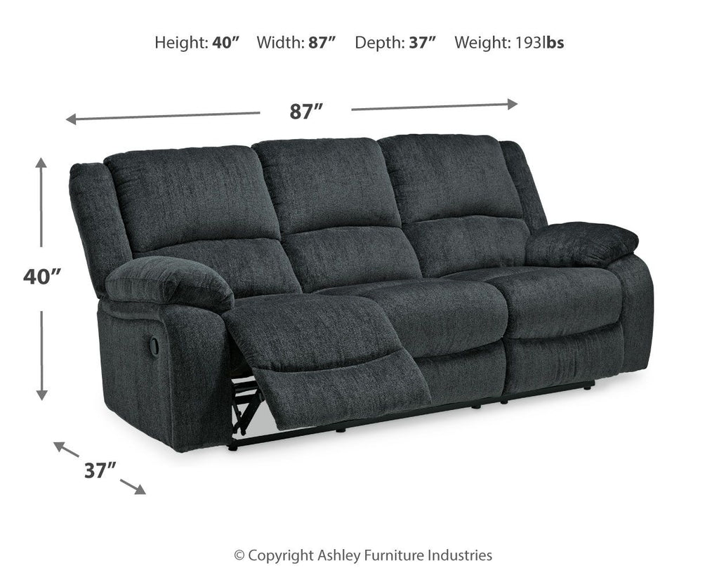 Draycoll reclining sofa in slate shown with reclined footrest, tufted back and arms