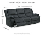 Draycoll reclining sofa in slate shown with reclined footrest, tufted back and arms