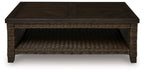 Rectangular patio coffee table with dark brown tabletop and woven base with open shelf