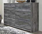 Gray six-drawer dresser with wide side panel and smooth drawer fronts, bar pulls