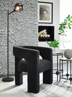 Dark charcoal upholstered accent chair with rounded seat and sturdy block legs