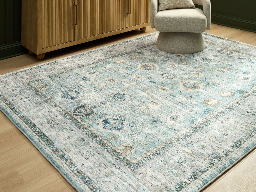 Ladstoney rug featuring medallion design in pale blue with beige framing border