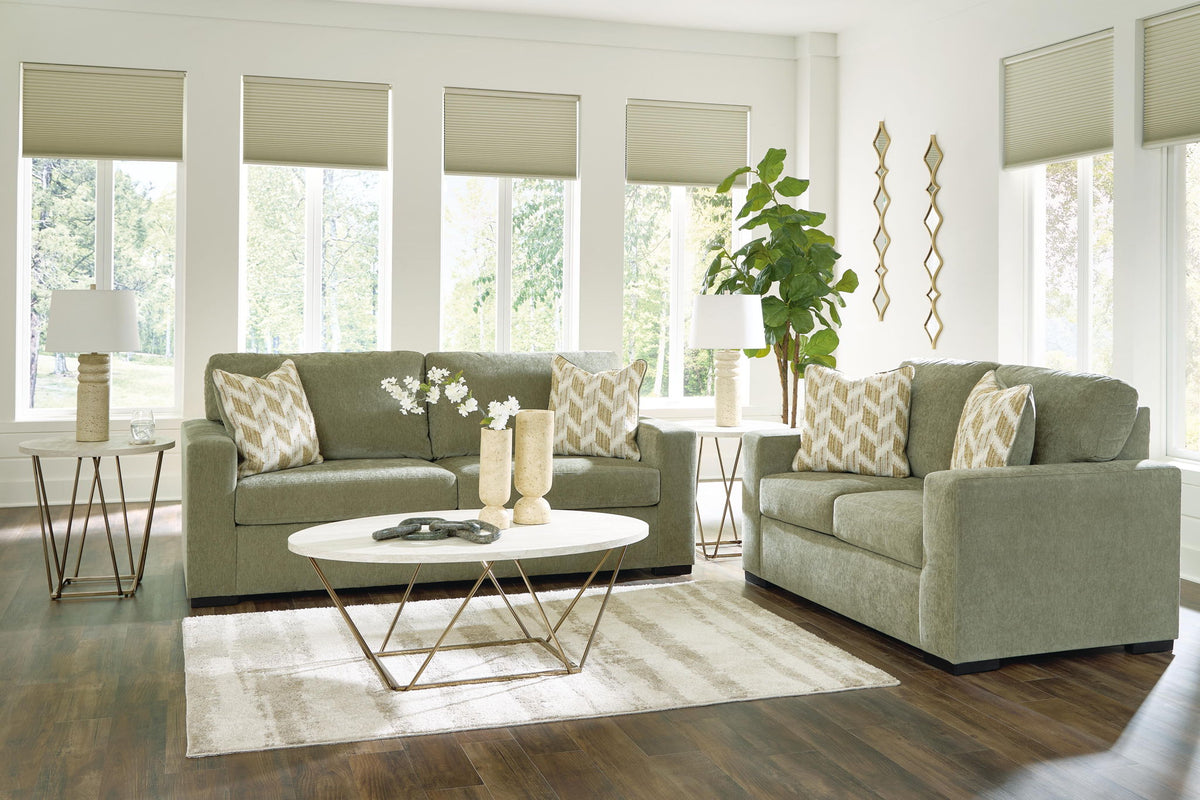 Living room set: green sofa and loveseat with beige patterned cushions
