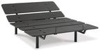 Adjustable bed base in black with layered slats, side lever, and four legs