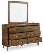 Brown dresser with mirror, four drawers visible, brass bar pulls, tapered feet