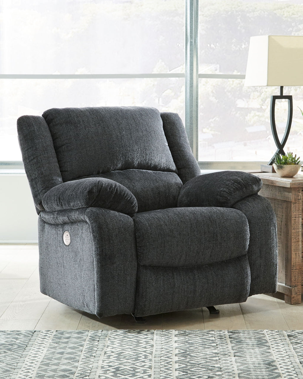 Slate fabric rocker recliner chair angled view with high back and plush armrests