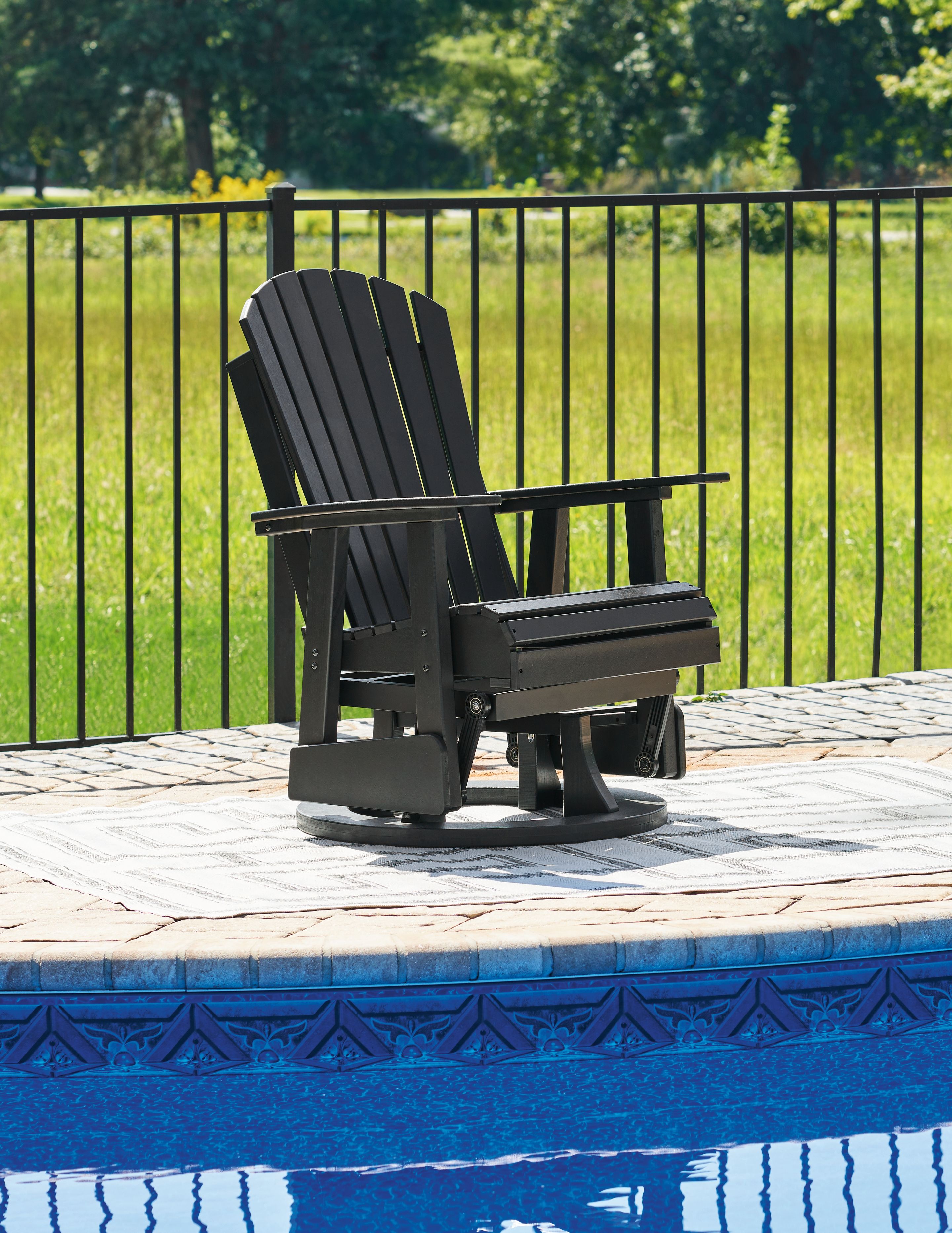 Black swivel glider chair with slat back, armrests, and horizontal seat platform.