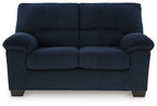 Upholstered loveseat, dark blue striped fabric, tufted back and padded arms