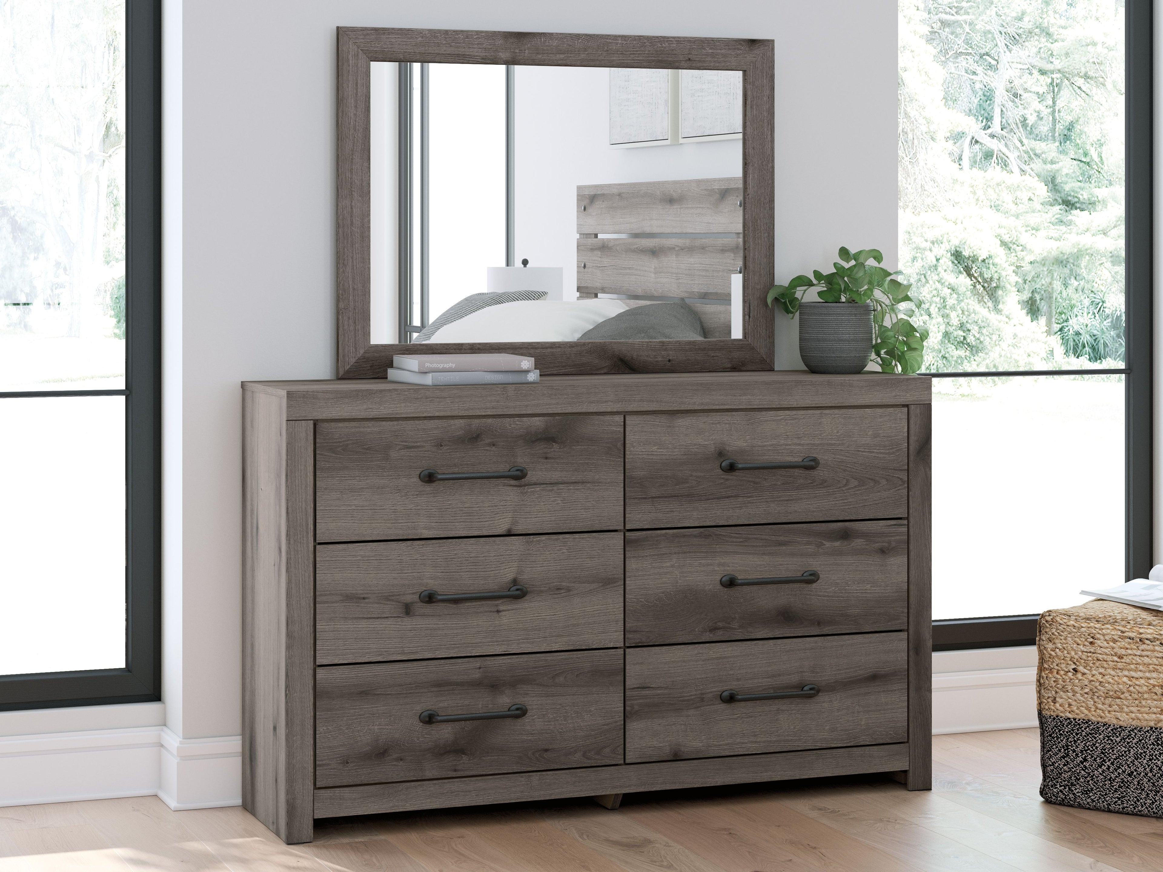 Gray-brown wooden dresser with mirror and six drawers with bar pulls